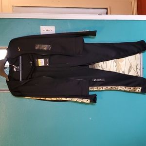 Nike tracksuit womens with gold logo on the sleeves and side of pants